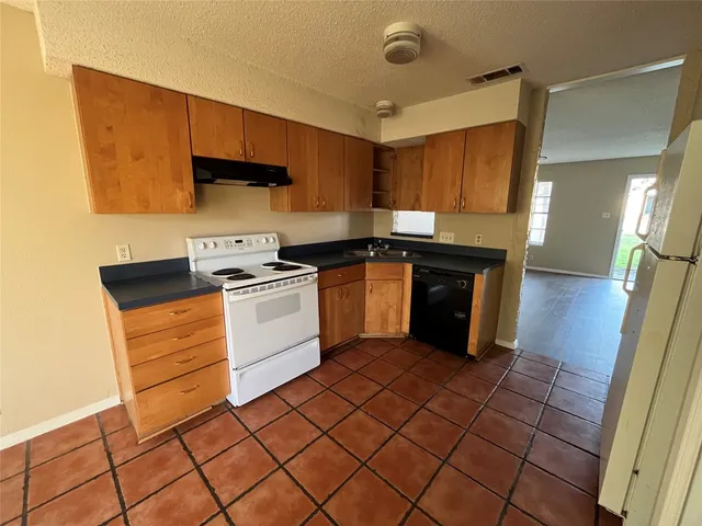 a kitchen with a sink and a stove top oven