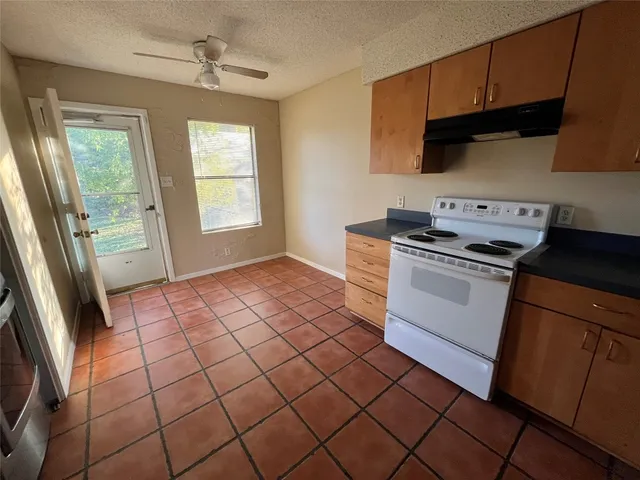 a kitchen with a stove a sink and a microwave
