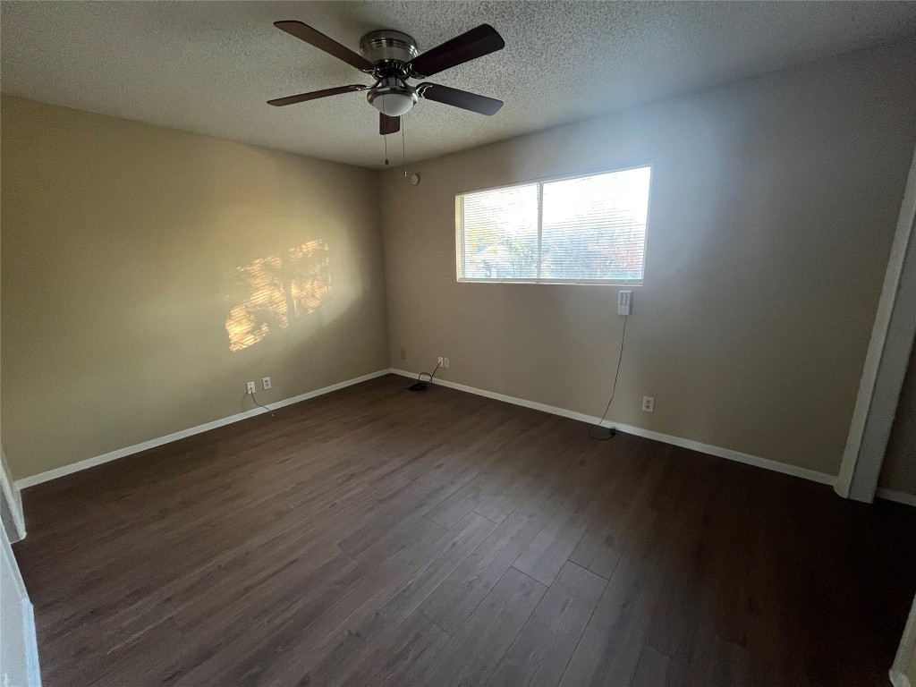 304-306 Highland Estates Drive, Unit 306 Round Rock, TX 78664 - Photo 7 of 10 a view of empty room with wooden floor and fan