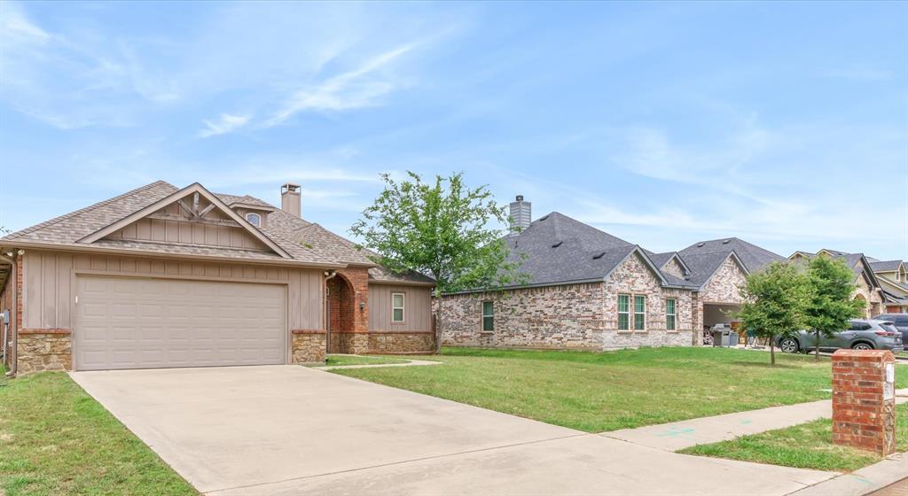 1852 Meadowview Canton, TX 75103 - Photo 2 of 28 a front view of a house with a yard and garage
