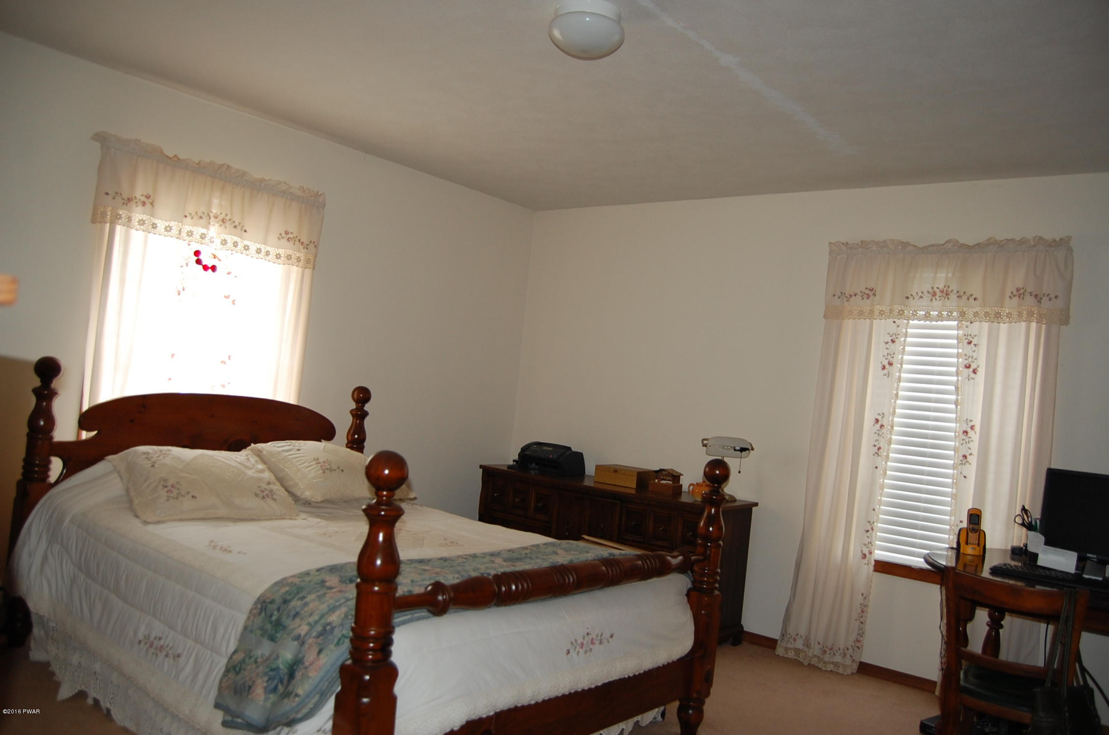 215 Maple Ridge Drive Hawley, PA 18428 - Photo 8 of 14 a bedroom with a bed and a window