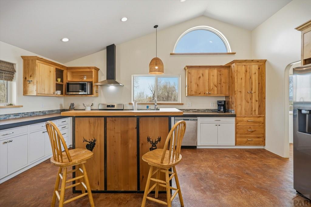 14285 County Rd E 5 Antonito, CO 81120 - Photo 11 of 72 a kitchen with a table chairs refrigerator and cabinets