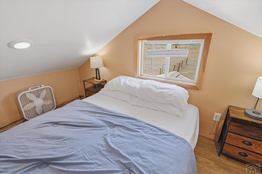 14285 County Rd E 5 Antonito, CO 81120 - Photo 52 of 72 a bedroom with a bed and wooden floor
