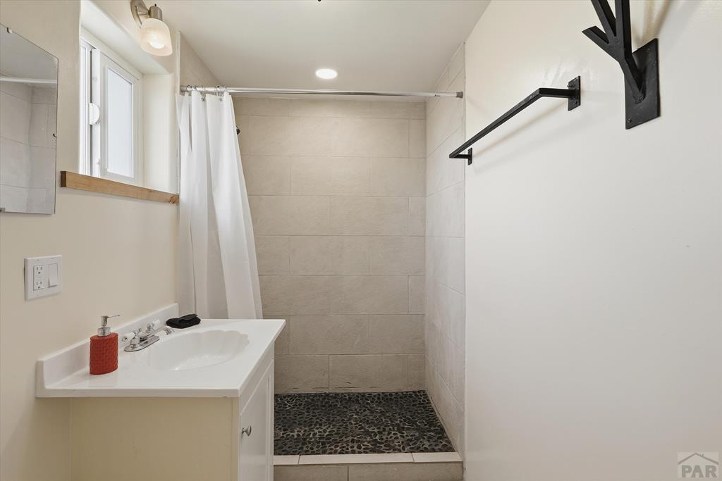 14285 County Rd E 5 Antonito, CO 81120 - Photo 61 of 72 a bathroom with a sink a mirror and a shower