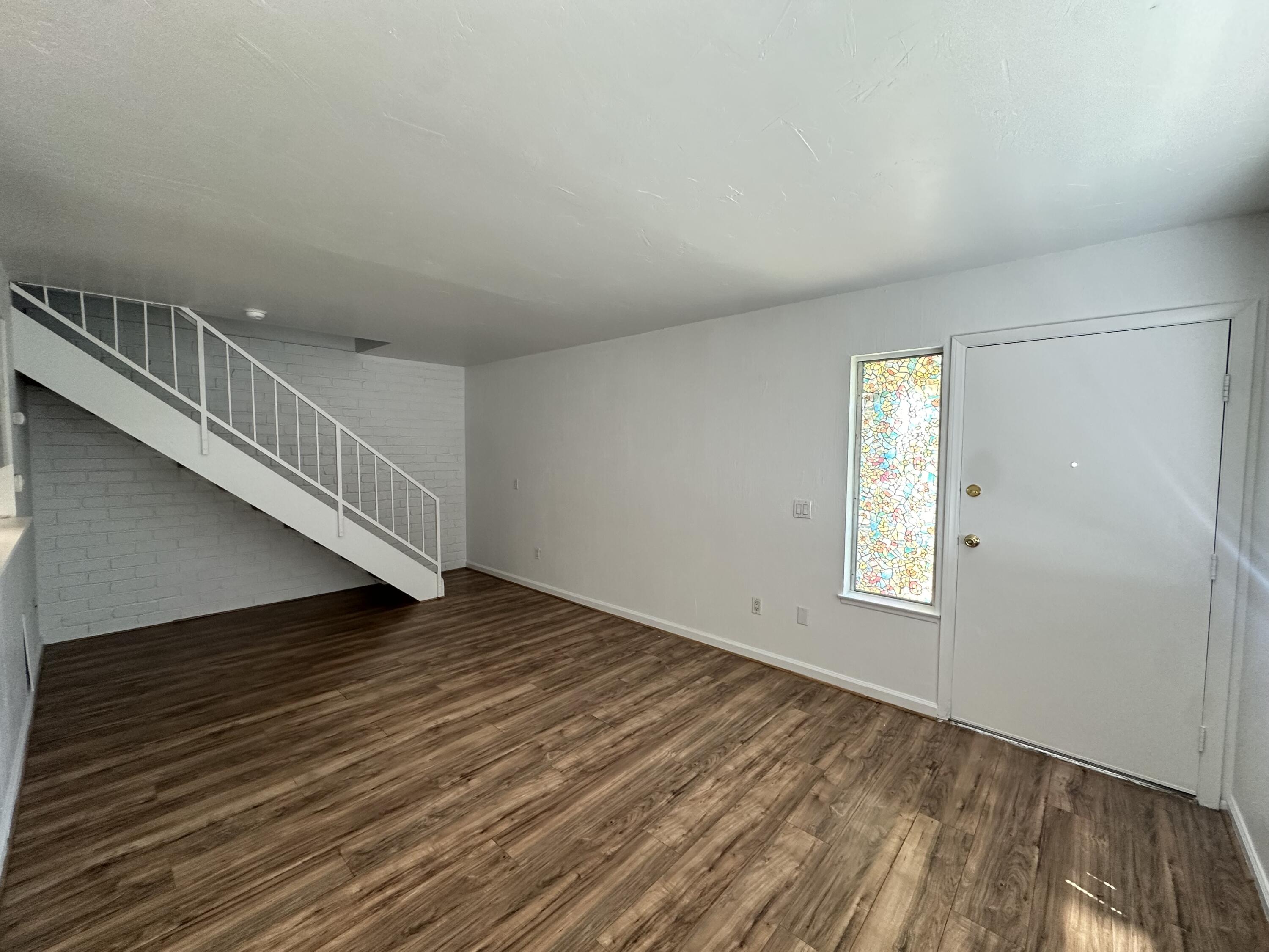 72631 Thrush Road, Unit 2 Palm Desert, CA 92260 - Photo 4 of 20 a view of an empty room with wooden floor and a window