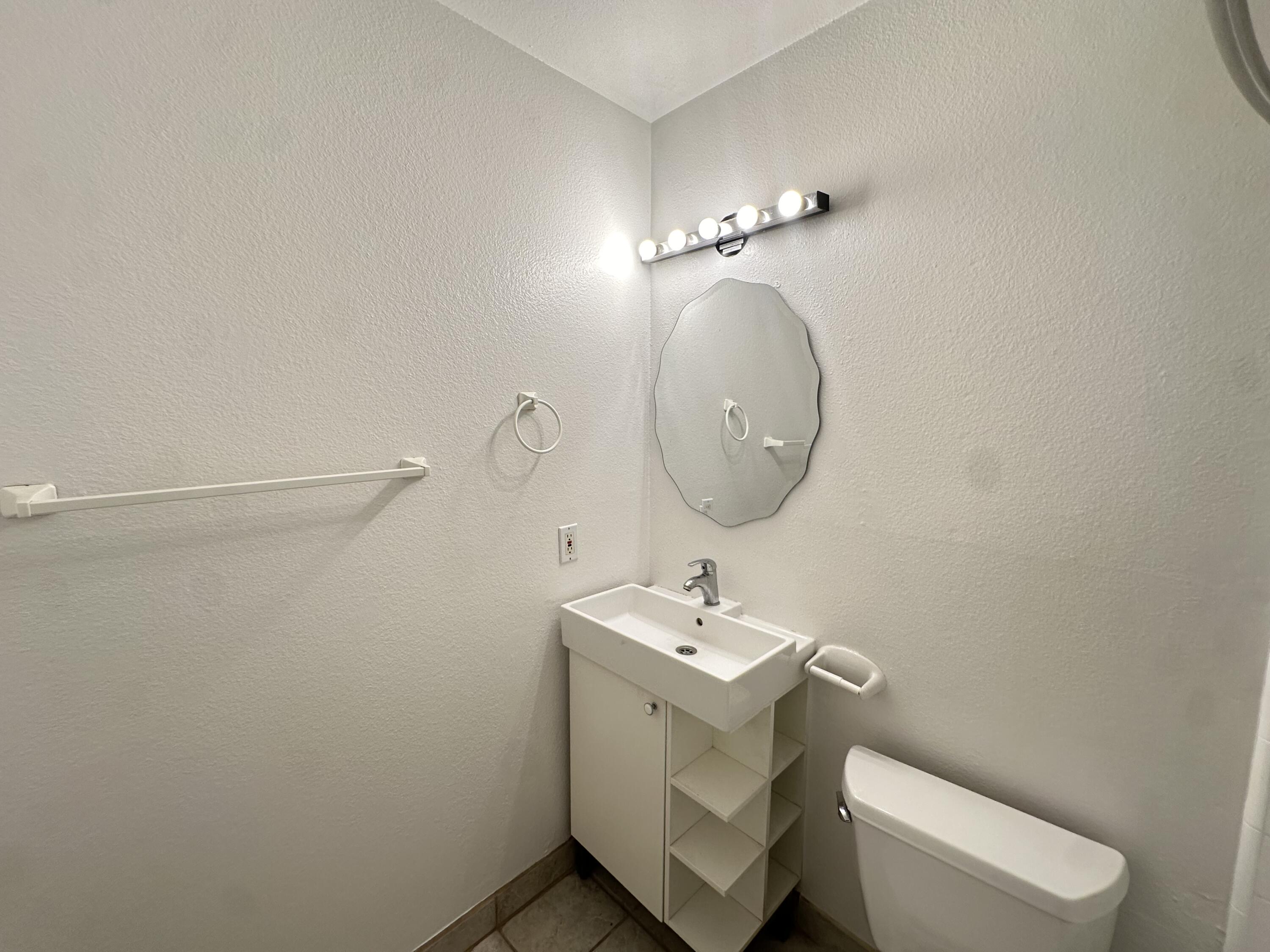 72631 Thrush Road, Unit 2 Palm Desert, CA 92260 - Photo 8 of 20 a bathroom with a toilet sink and mirror