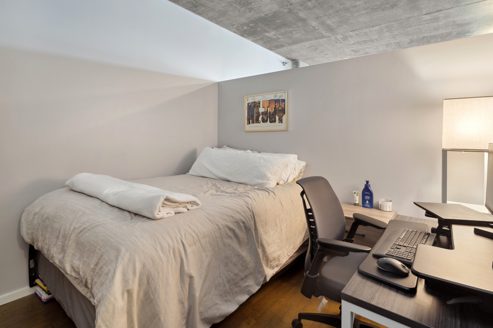 321 South Sangamon Street, Unit 603 Chicago, IL 60607 - Photo 4 of 12 a bedroom with a bed and wooden floor