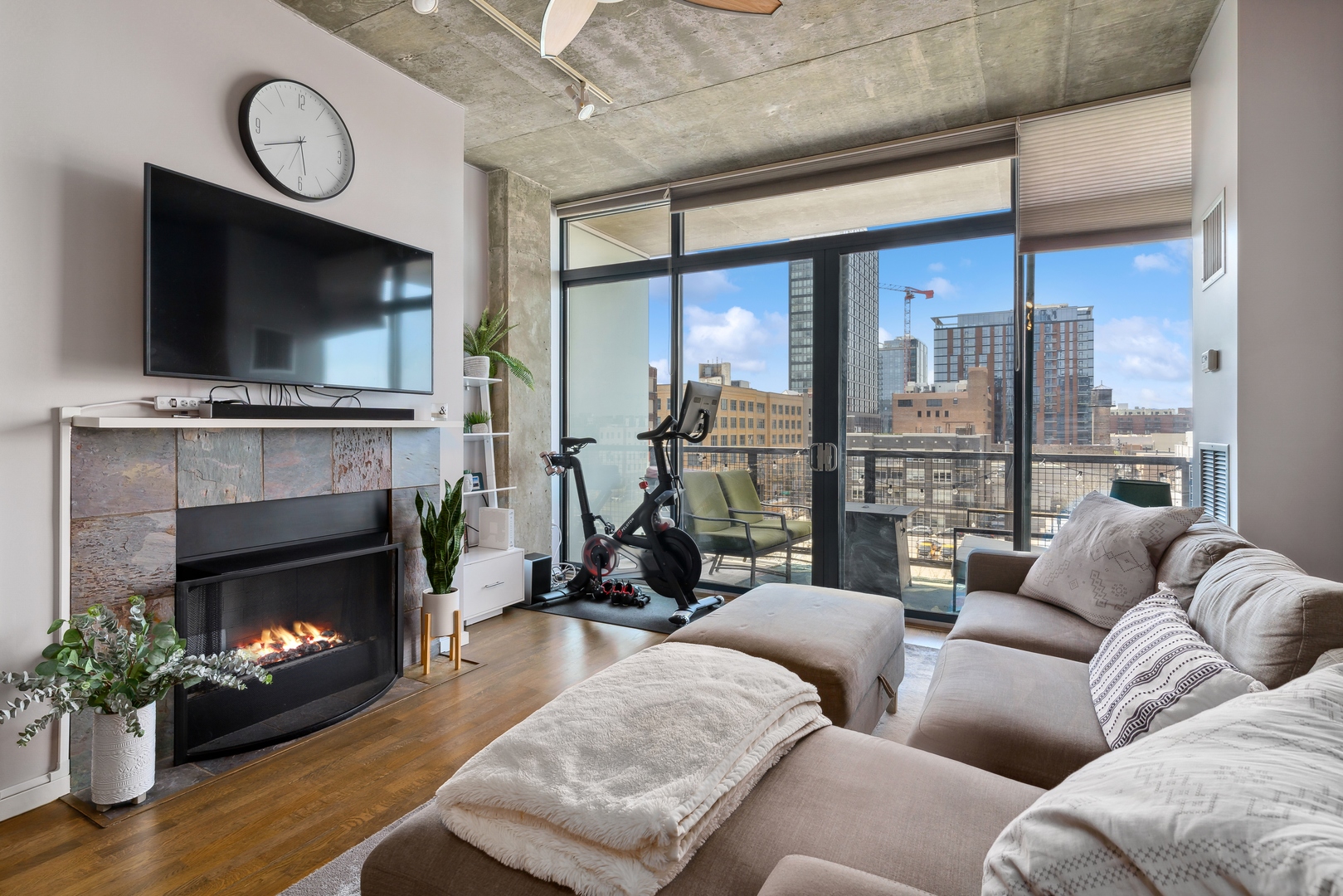 321 South Sangamon Street, Unit 603 Chicago, IL 60607 - Photo 6 of 12 a living room with furniture a flat screen tv and a fireplace