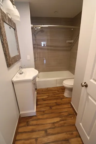 a bathroom with a sink toilet and shower