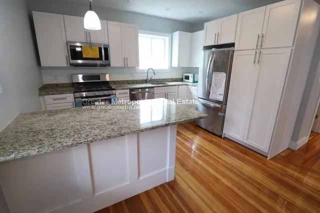 a kitchen with stainless steel appliances a refrigerator sink and microwave