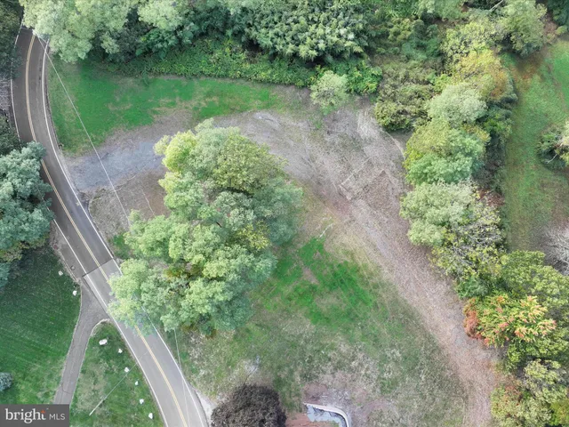 a view of a water pond with green yard