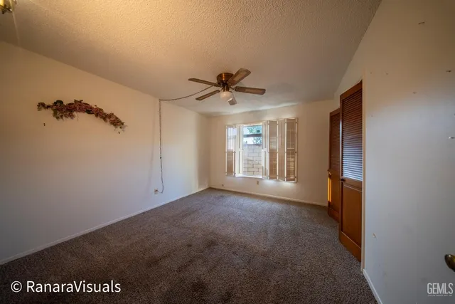 a view of a livingroom with a ceiling fan and window