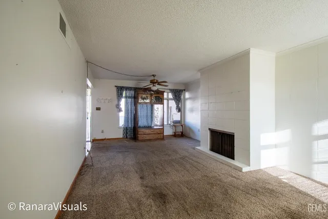 a view of empty room with fireplace