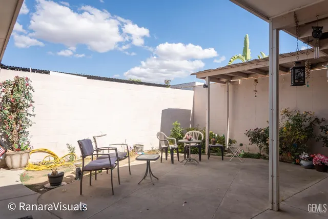 a view of a patio with table and chairs and potted plants