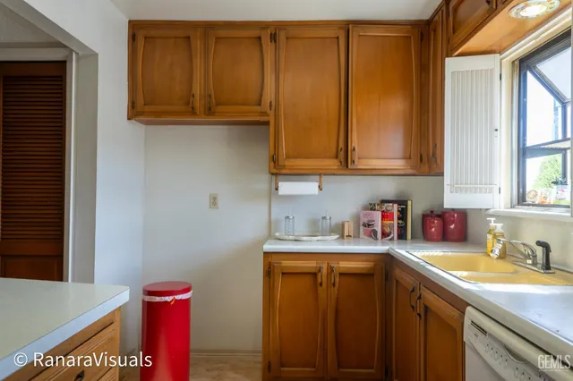 a kitchen with a sink cabinets and a window