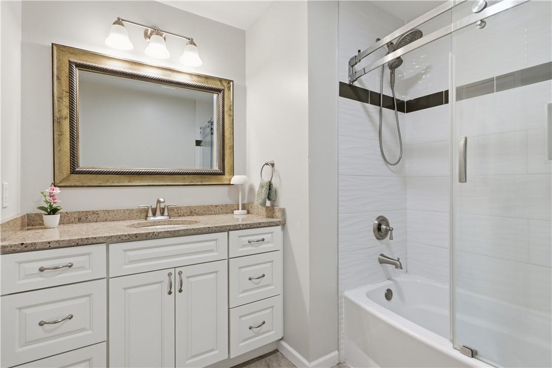 2057 Stirnie Road Victor, NY 14564 - Photo 28 of 48 The second floor features a beautifully updated full bathroom complete with durable hard-surface flooring, a wide vanity with ample storage space, and bright overhead lighting.
