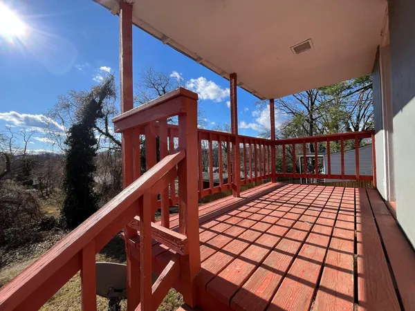 a view of a balcony with wooden floor