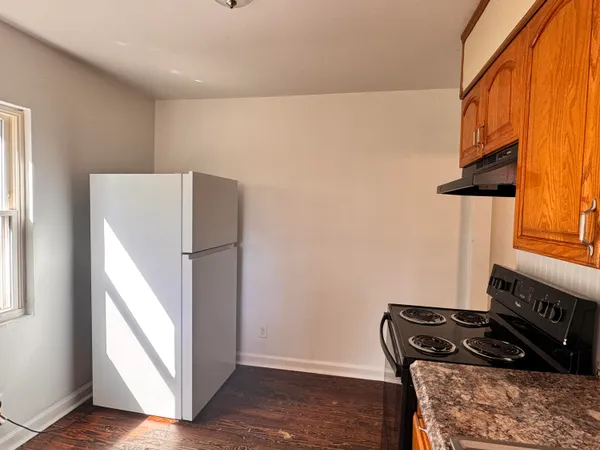 a kitchen with a stove and a refrigerator