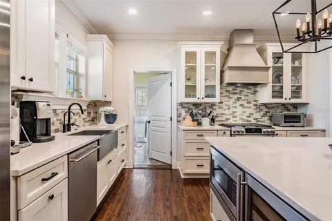 a kitchen with a sink stove and cabinets