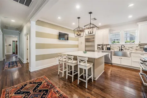 a large kitchen with a table and chairs