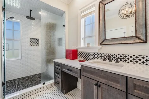 a bathroom with a shower and a mirror