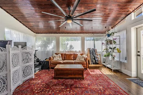 a bedroom with a bed couch and a flat screen tv
