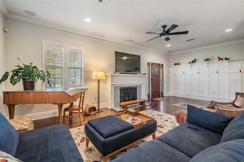 a living room with furniture a flat screen tv and a fireplace