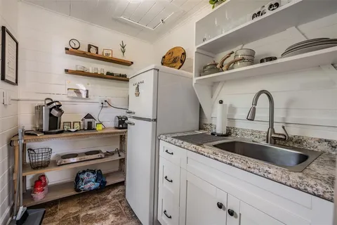 a bathroom with a granite countertop sink toilet a mirror and shower
