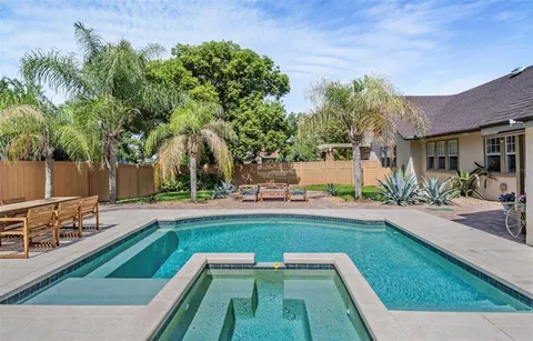 a view of swimming pool with seating space