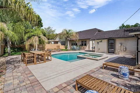 a view of a house with swimming pool and sitting area