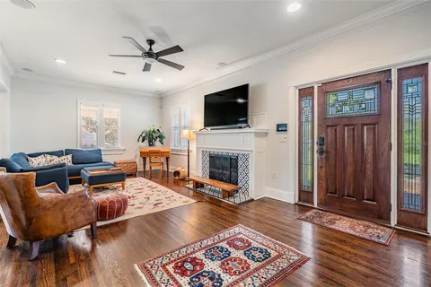 a living room with furniture fireplace and flat screen tv