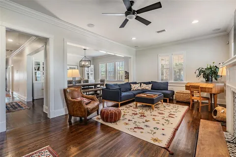 a living room with lots of furniture and a wooden floor
