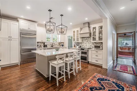 a kitchen with stainless steel appliances granite countertop a sink stove and wooden floor