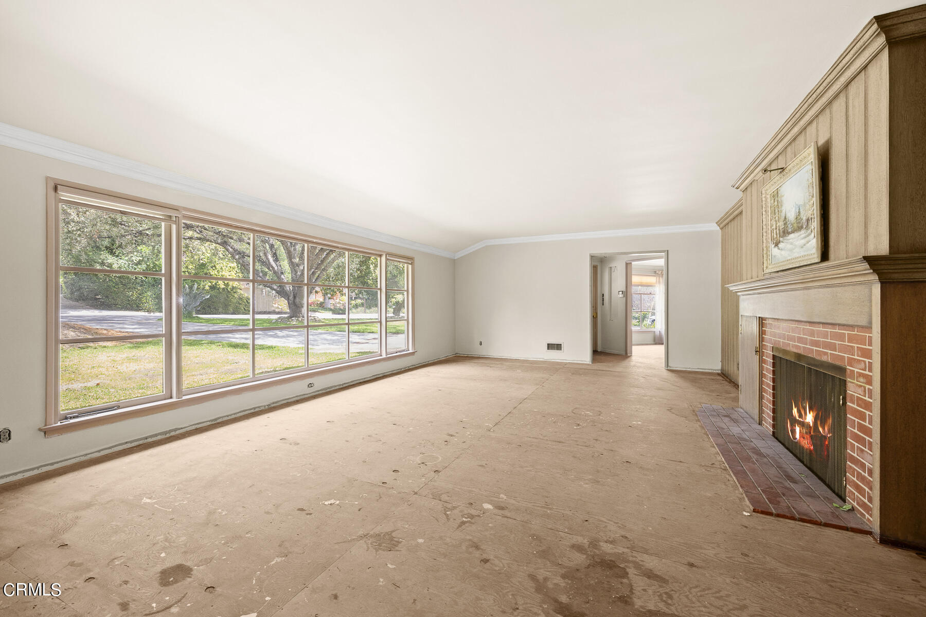 3570 Lombardy Road Pasadena, CA 91107 - Photo 12 of 45 a view of an empty room with a fireplace and a window