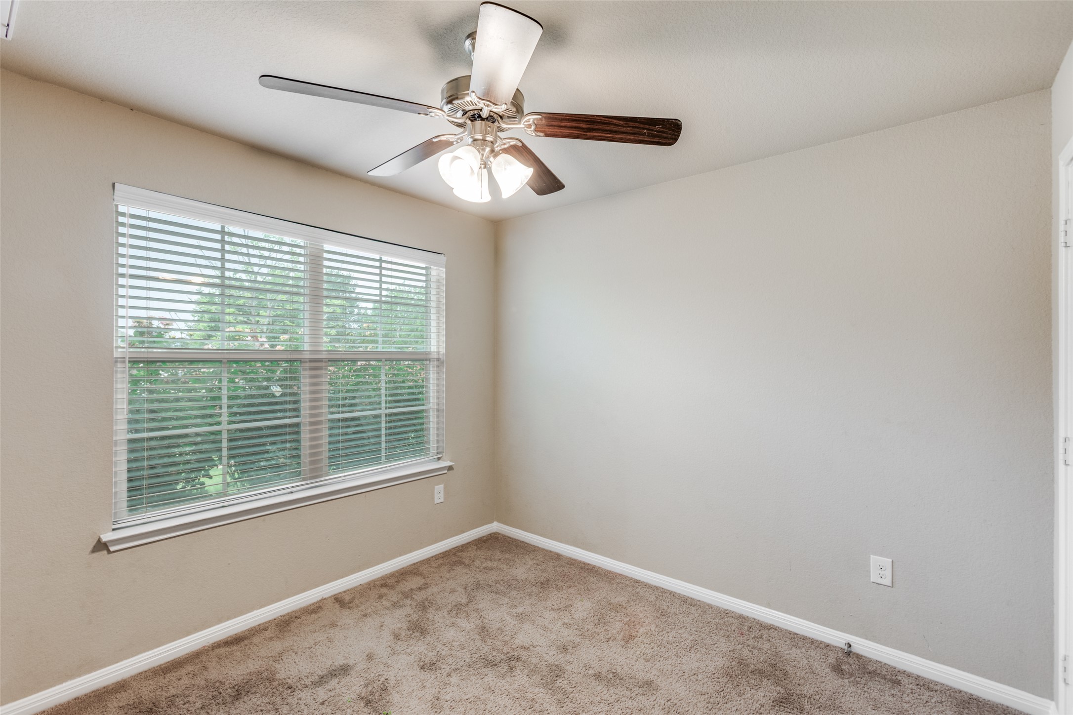 2909 Centrum Drive Austin, TX 78754 - Photo 23 of 30 This room features a window with blinds, carpeted flooring, and a ceiling fan with integrated lighting
