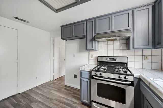 a kitchen with stainless steel appliances granite countertop a stove and a refrigerator