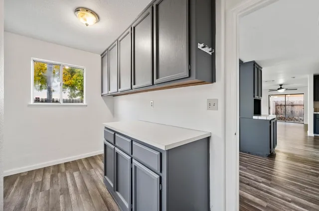 a kitchen with stainless steel appliances granite countertop a refrigerator a stove and a wooden floors