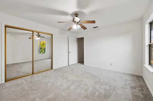 a view of empty room with ceiling fan