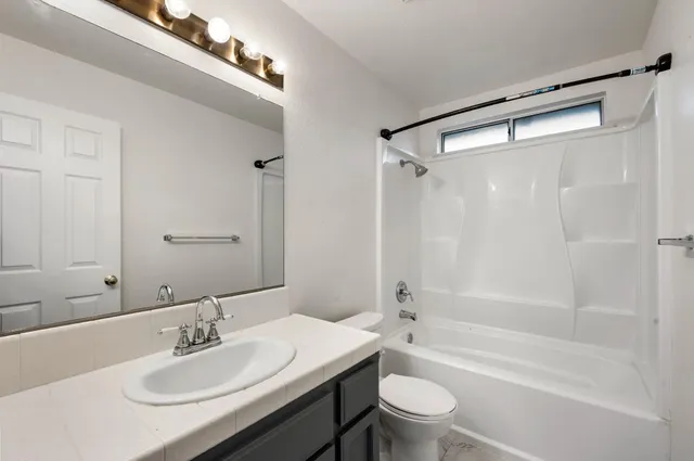 a bathroom with a sink toilet tub and shower