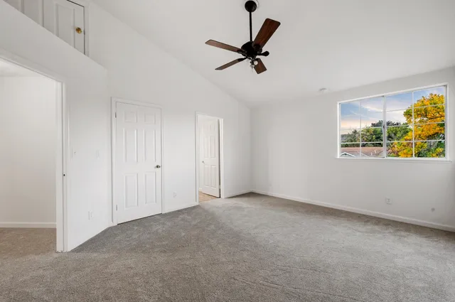 a view of room with window and ceiling fan