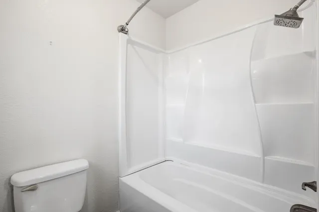 a bathroom with a bathtub and a toilet