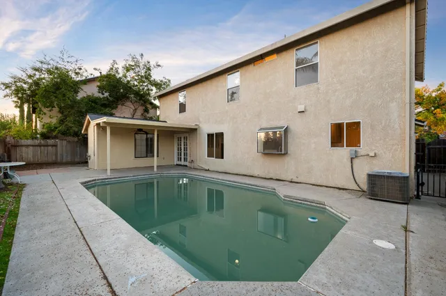 a view of a house with a backyard and a patio