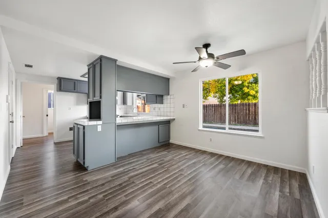 a view of kitchen with sink microwave refrigerator and outdoor view