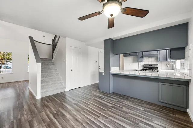 a kitchen with stainless steel appliances granite countertop a sink and cabinets