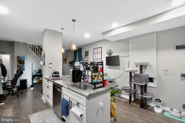 a view of a kitchen with workspace and living room