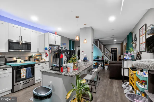 a living room with lots of furniture and a wooden floors