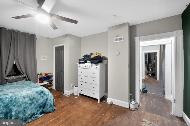 a bedroom with a bed and a dresser