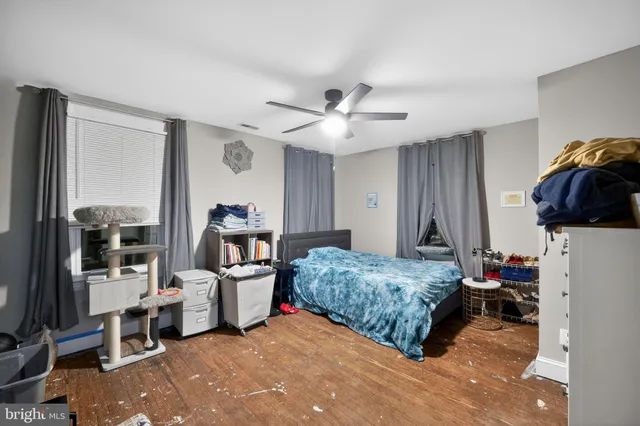 a living room with a bed furniture and a flat tv screen