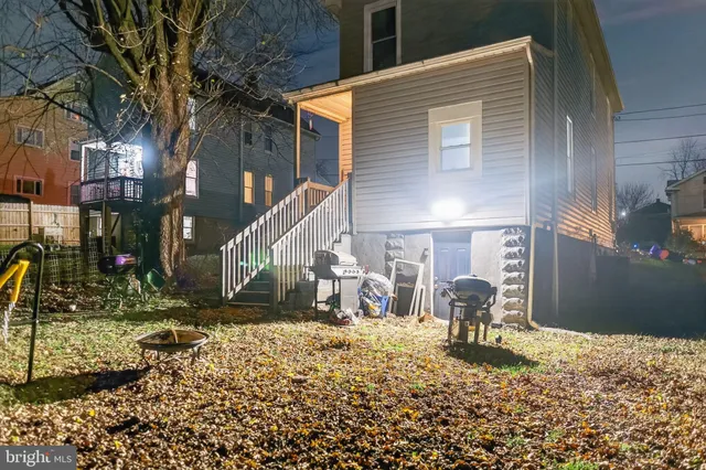 a backyard of a house with table and chairs