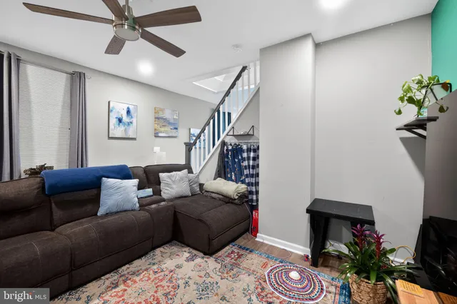 a living room with furniture and a potted plant